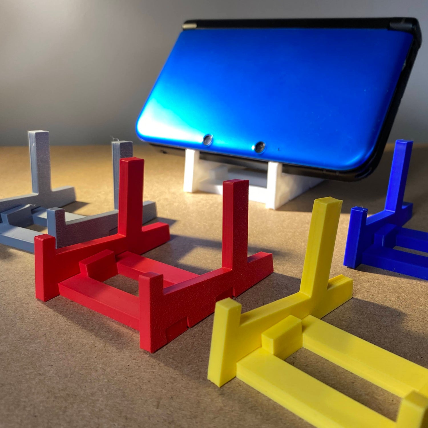 Colorful plastic stands with a tablet on a gray surface