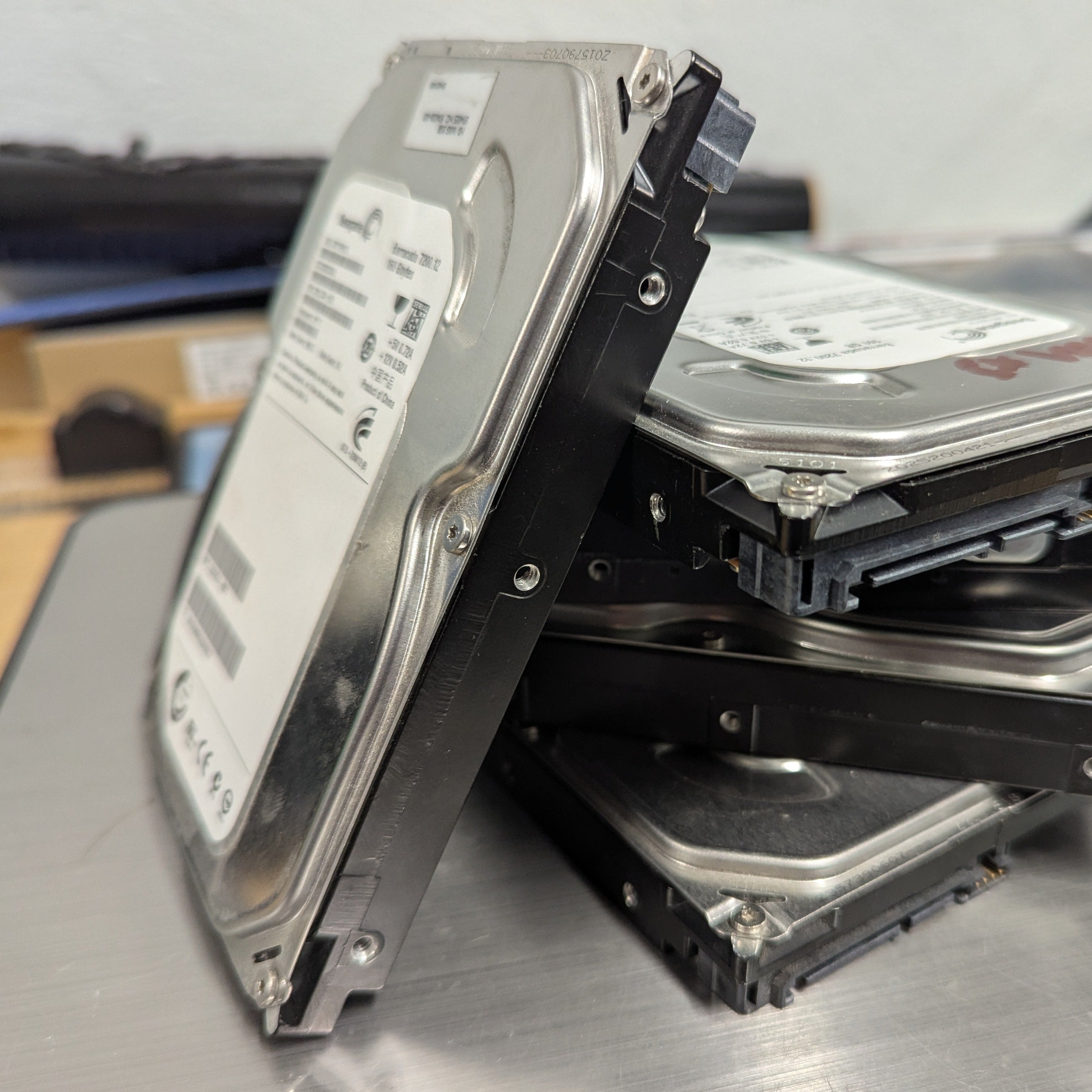 Stack of hard disk drives on a metallic surface