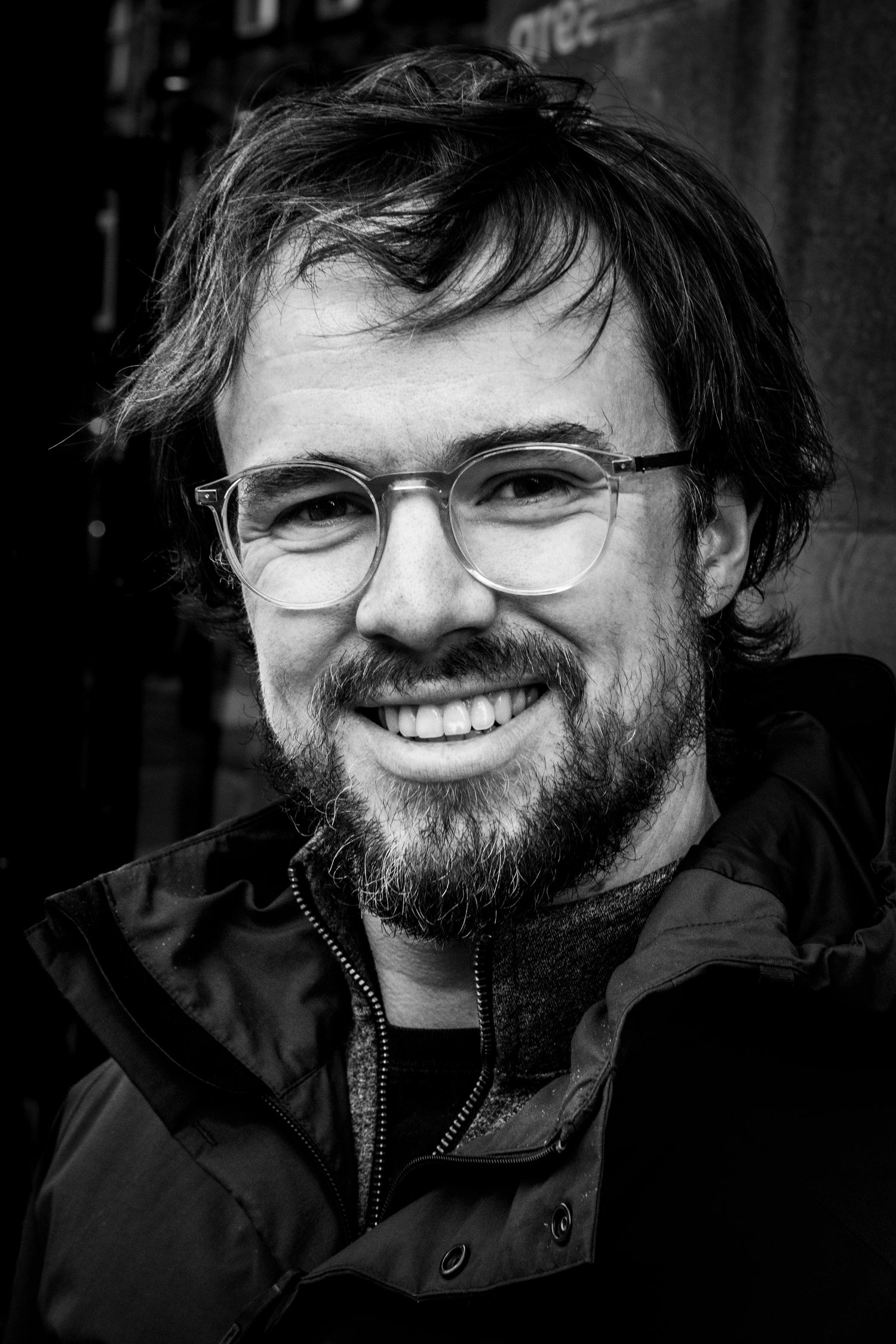 Man with glasses and a beard looking a bit windswept