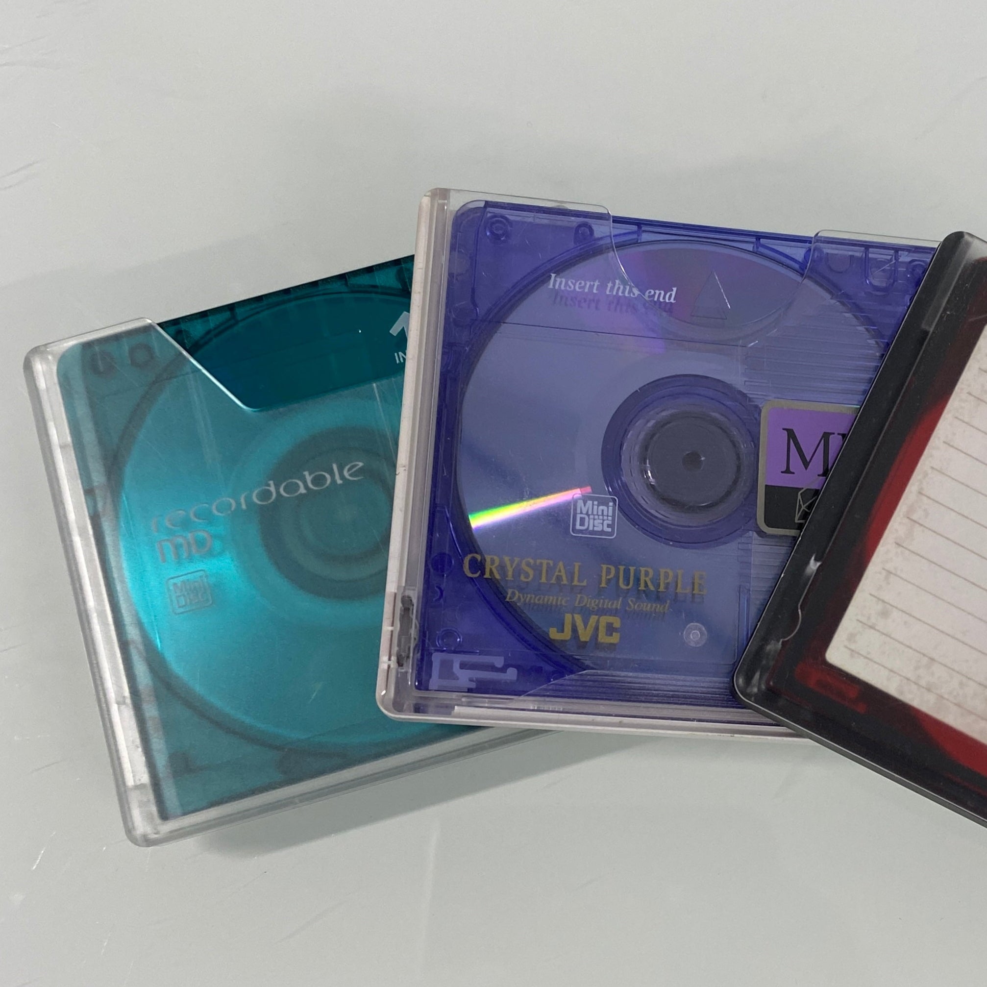 Two audio cassettes with visible labels on a white background